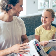 Father Reads Newspaper with Daughter
