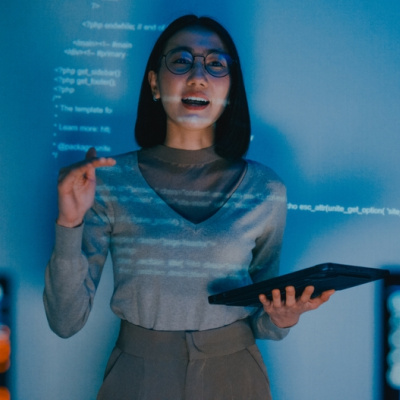 Female software developer manager presenting a strategy plan through a projected slideshow.