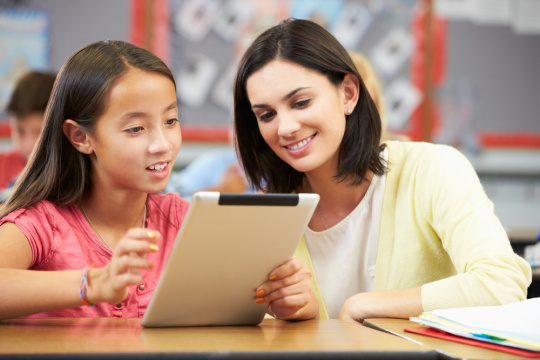 Teacher and student looking at tablet
