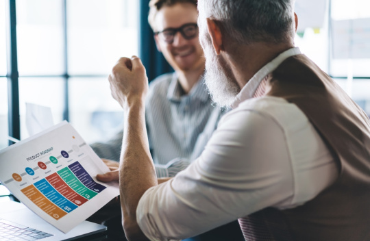 Two team members discuss their edtech company’s project roadmap.