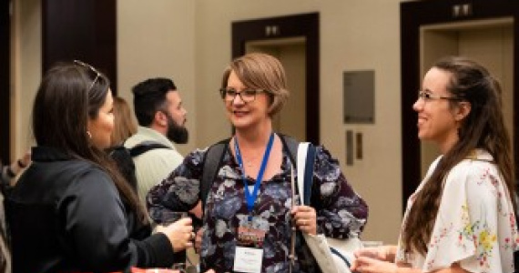 Three people chatting at the EdWeek Market Brief Summit.