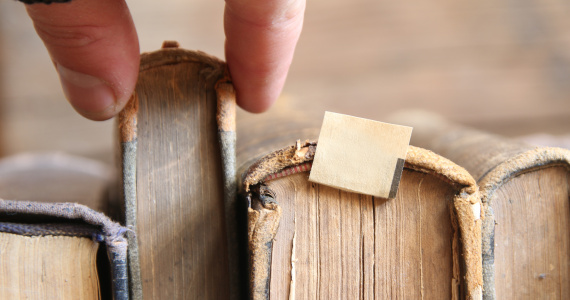 Book stack hand choosing one