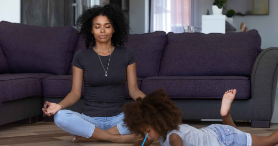 Mother meditating at home