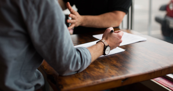 hands at desk talking coaching