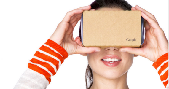 woman holding up google cardboard to her face