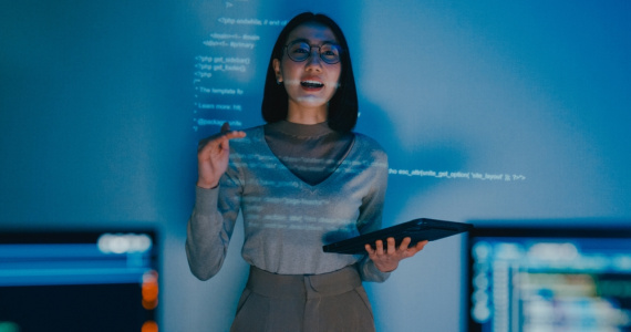 Female software developer manager presenting a strategy plan through a projected slideshow.