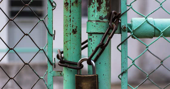 padlock around green fence