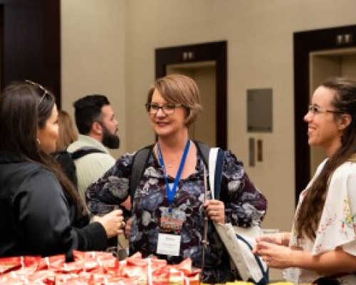 Three people chatting at the EdWeek Market Brief Summit.
