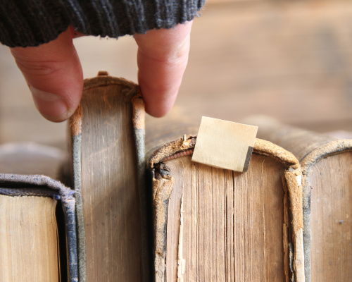 Book stack hand choosing one