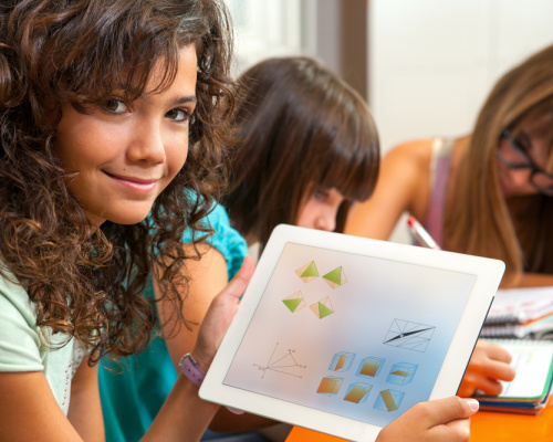 Girl showing tablet with math manipulatives on screen