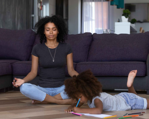 Mother meditating at home