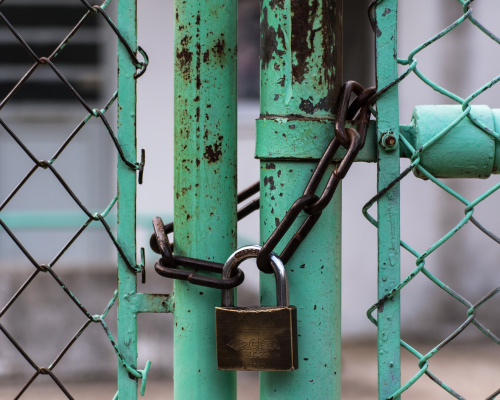 padlock around green fence