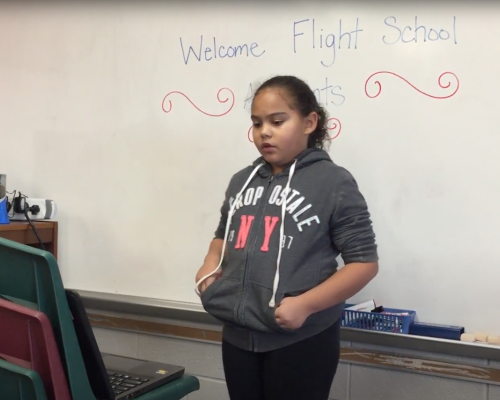 A student presenting her application letter to enter the Flight School.